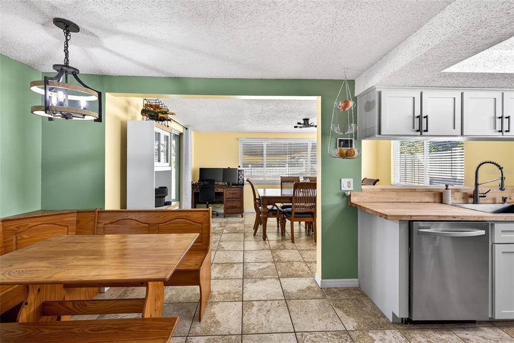 7325 Neva Lane Port Richey, FL 34668 - Photo 14 of 36 a room with kitchen island a table and chairs