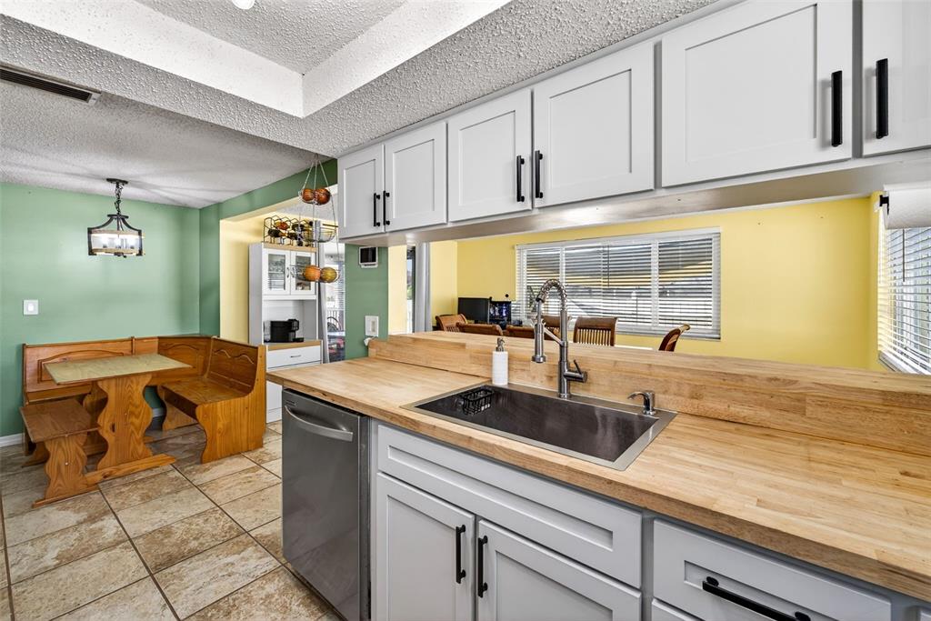 7325 Neva Lane Port Richey, FL 34668 - Photo 19 of 36 a kitchen with stainless steel appliances granite countertop a sink and cabinets