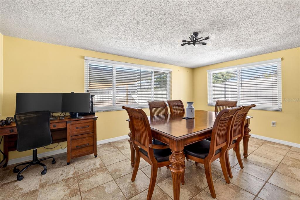 7325 Neva Lane Port Richey, FL 34668 - Photo 20 of 36 a view of a dining room with furniture and a window