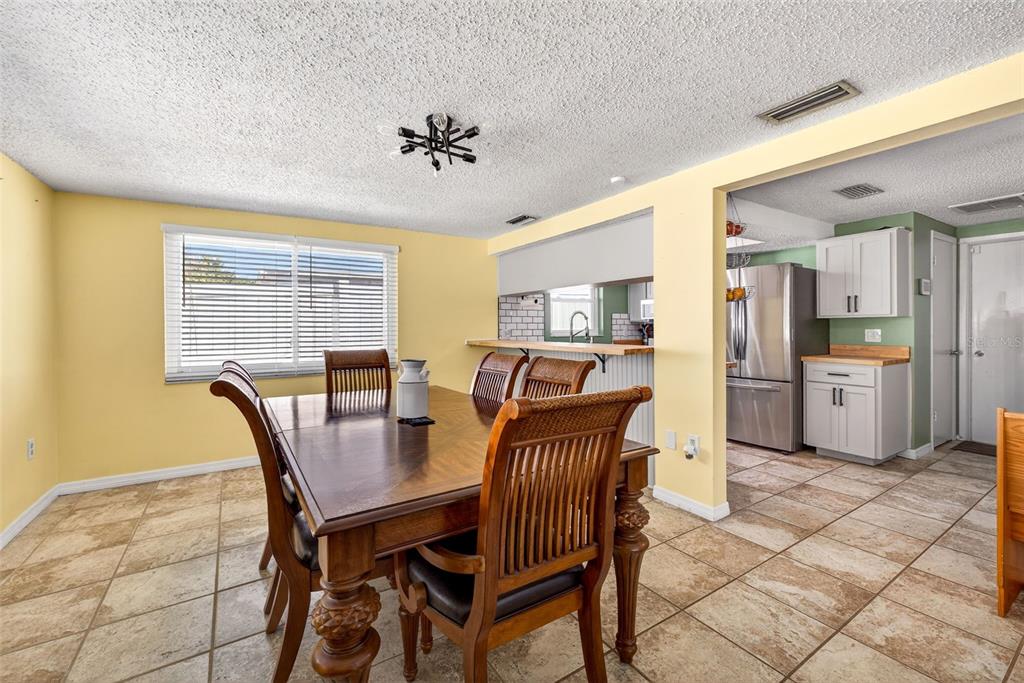 7325 Neva Lane Port Richey, FL 34668 - Photo 21 of 36 a view of a dining room with furniture and a chandelier