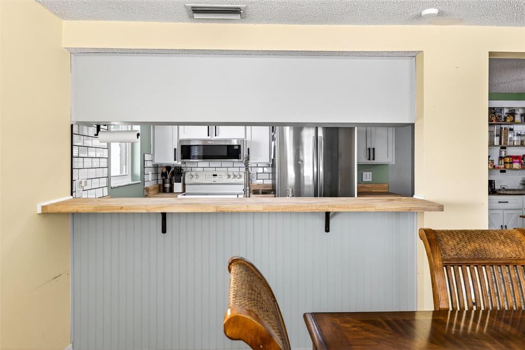 7325 Neva Lane Port Richey, FL 34668 - Photo 22 of 36 a kitchen with stainless steel appliances a microwave a stove and white cabinets