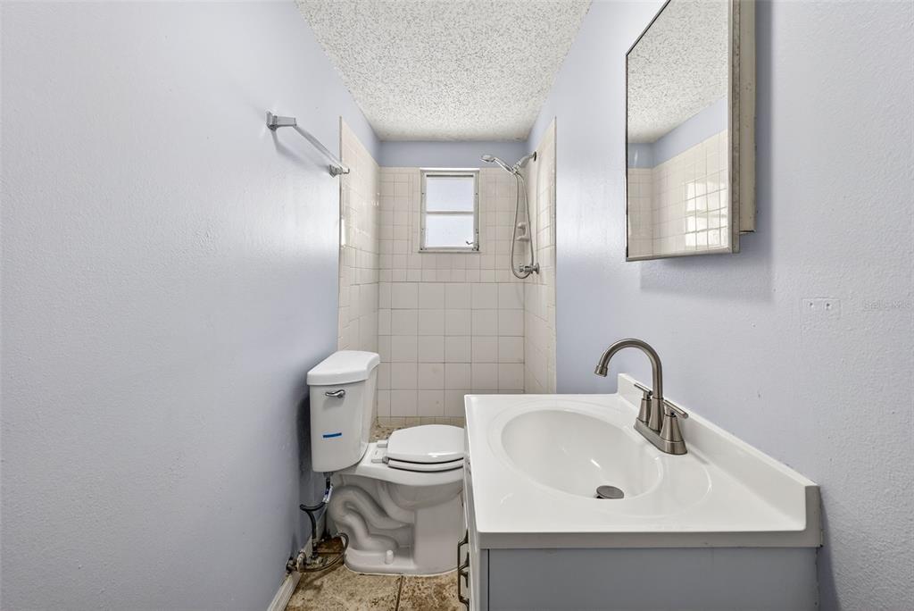 7325 Neva Lane Port Richey, FL 34668 - Photo 24 of 36 a bathroom with a toilet sink and mirror