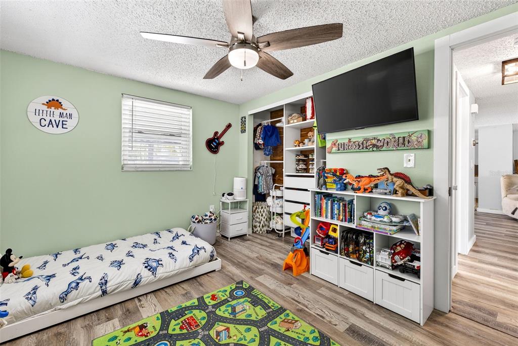 7325 Neva Lane Port Richey, FL 34668 - Photo 26 of 36 a bed room with furniture and a flat screen tv