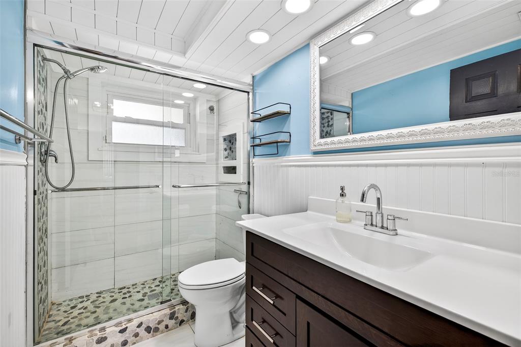 7325 Neva Lane Port Richey, FL 34668 - Photo 29 of 36 a bathroom with a sink a toilet and shower