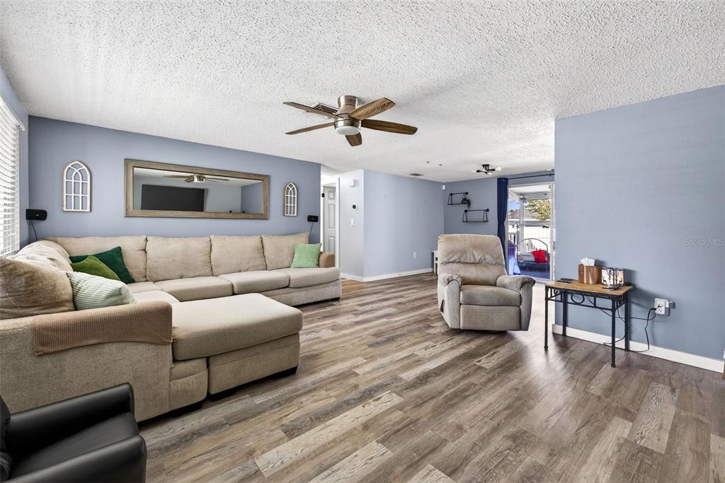 7325 Neva Lane Port Richey, FL 34668 - Photo 31 of 36 a living room with furniture and a wooden floor