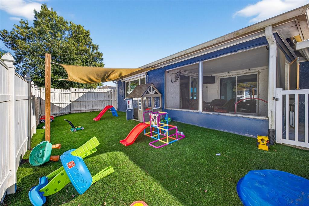7325 Neva Lane Port Richey, FL 34668 - Photo 6 of 36 a front view of a house with backyard and porch