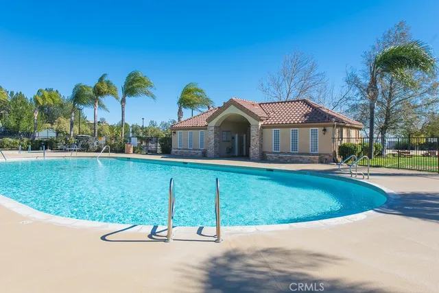 a house with swimming pool in front of it