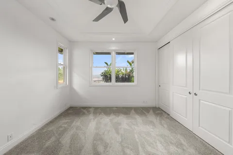 a bathroom with a granite countertop sink a toilet and shower