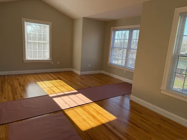 a view of a room with wooden floor and windows