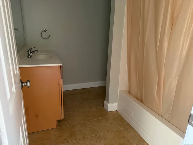 a kitchen with granite countertop a stove a sink and a microwave