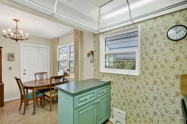 a dining room with a wooden table and chairs