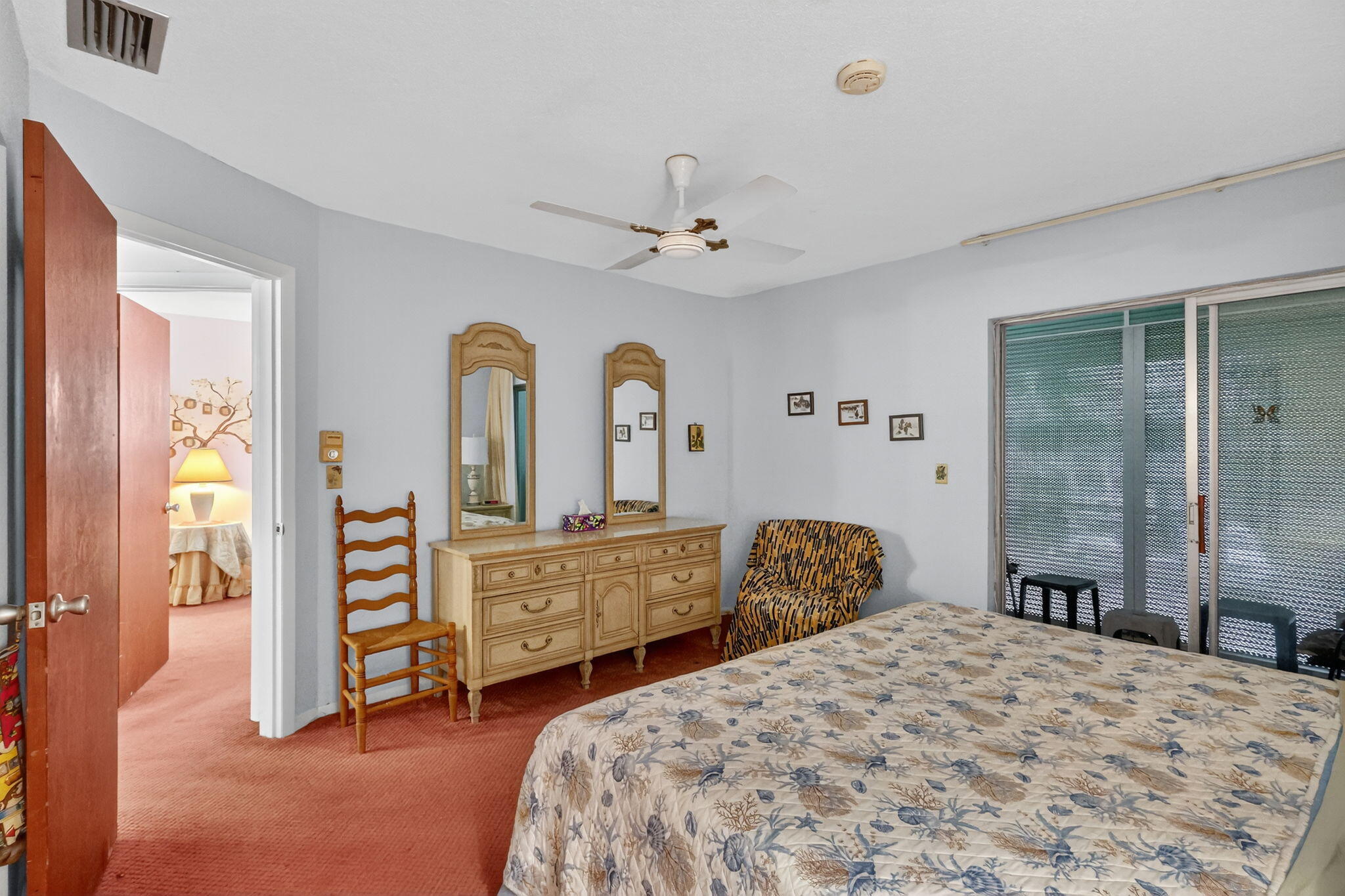 2929 Southeast Ocean Boulevard, Unit J10 Stuart, FL 34996 - Photo 13 of 29 a bedroom with a bed dresser and a window