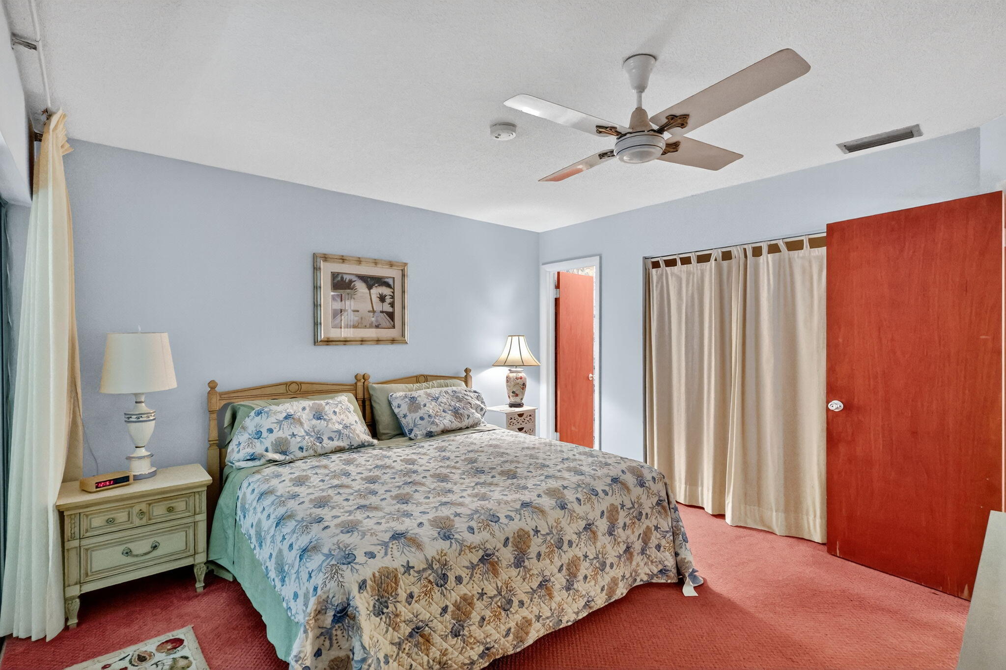 2929 Southeast Ocean Boulevard, Unit J10 Stuart, FL 34996 - Photo 14 of 29 a bedroom with a large bed and a chandelier