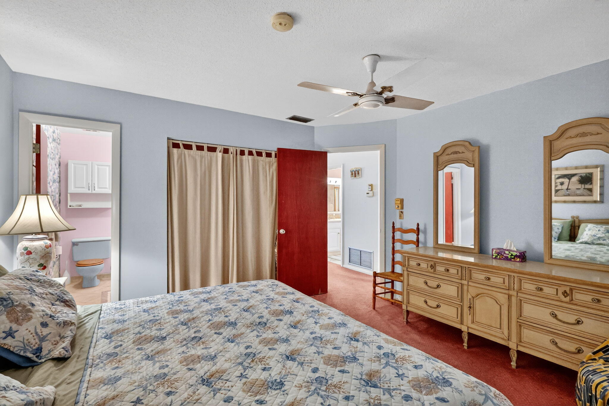 2929 Southeast Ocean Boulevard, Unit J10 Stuart, FL 34996 - Photo 15 of 29 a bedroom with a bed dresser and wooden floor