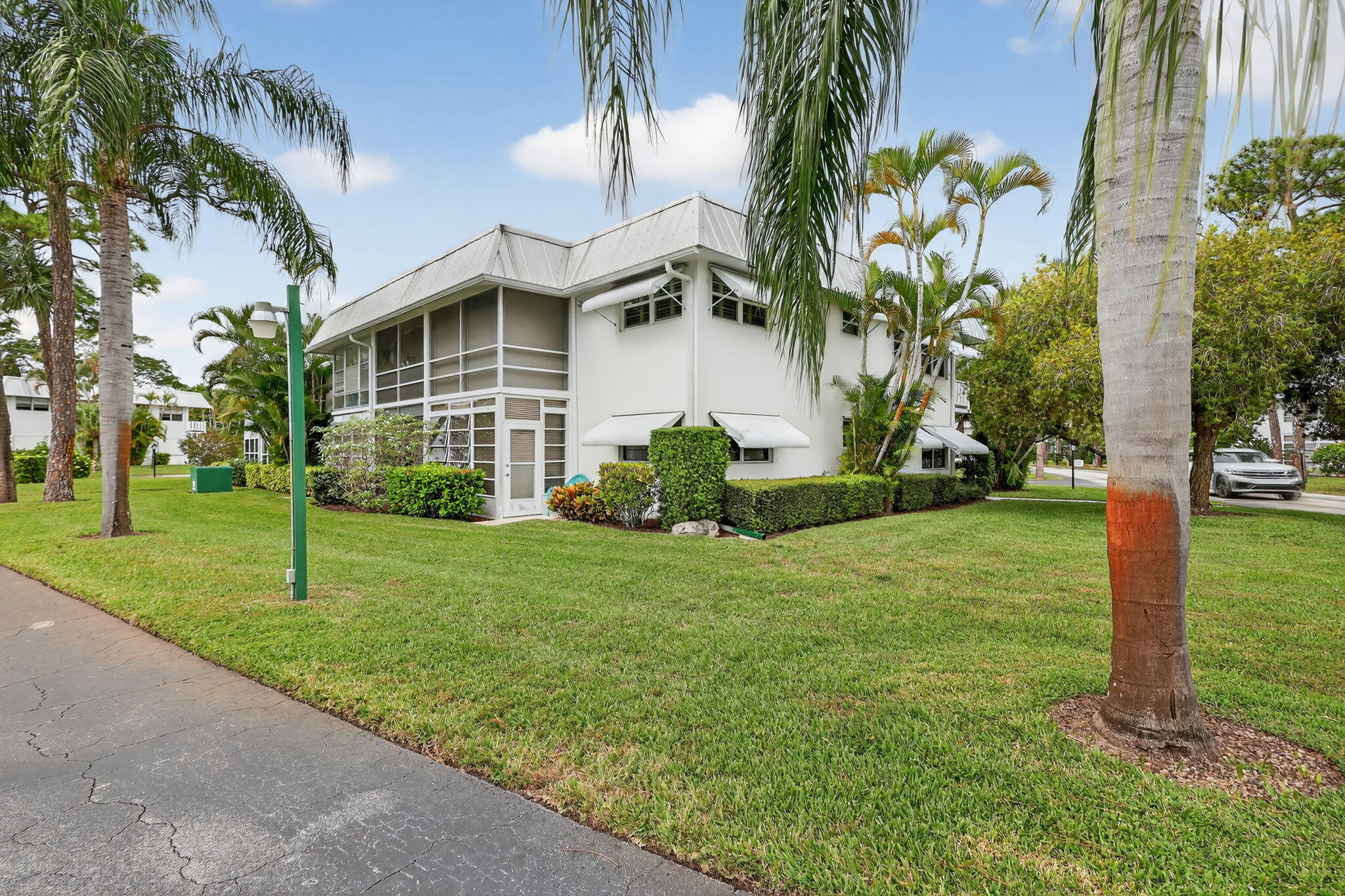 2929 Southeast Ocean Boulevard, Unit J10 Stuart, FL 34996 - Photo 25 of 29 front view of a house with a yard