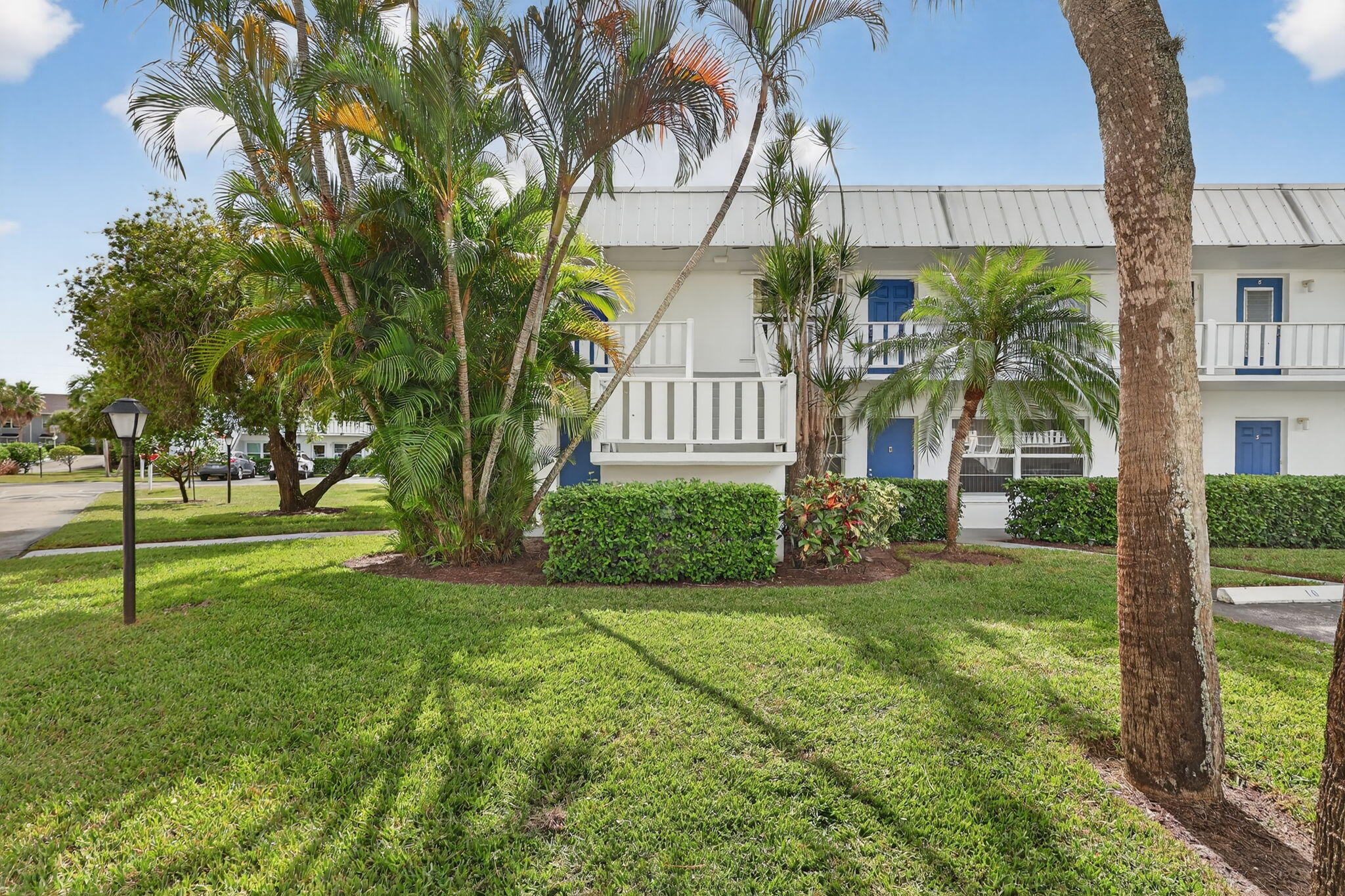 2929 Southeast Ocean Boulevard, Unit J10 Stuart, FL 34996 - Photo 29 of 29 a view of a house with a big yard and large trees