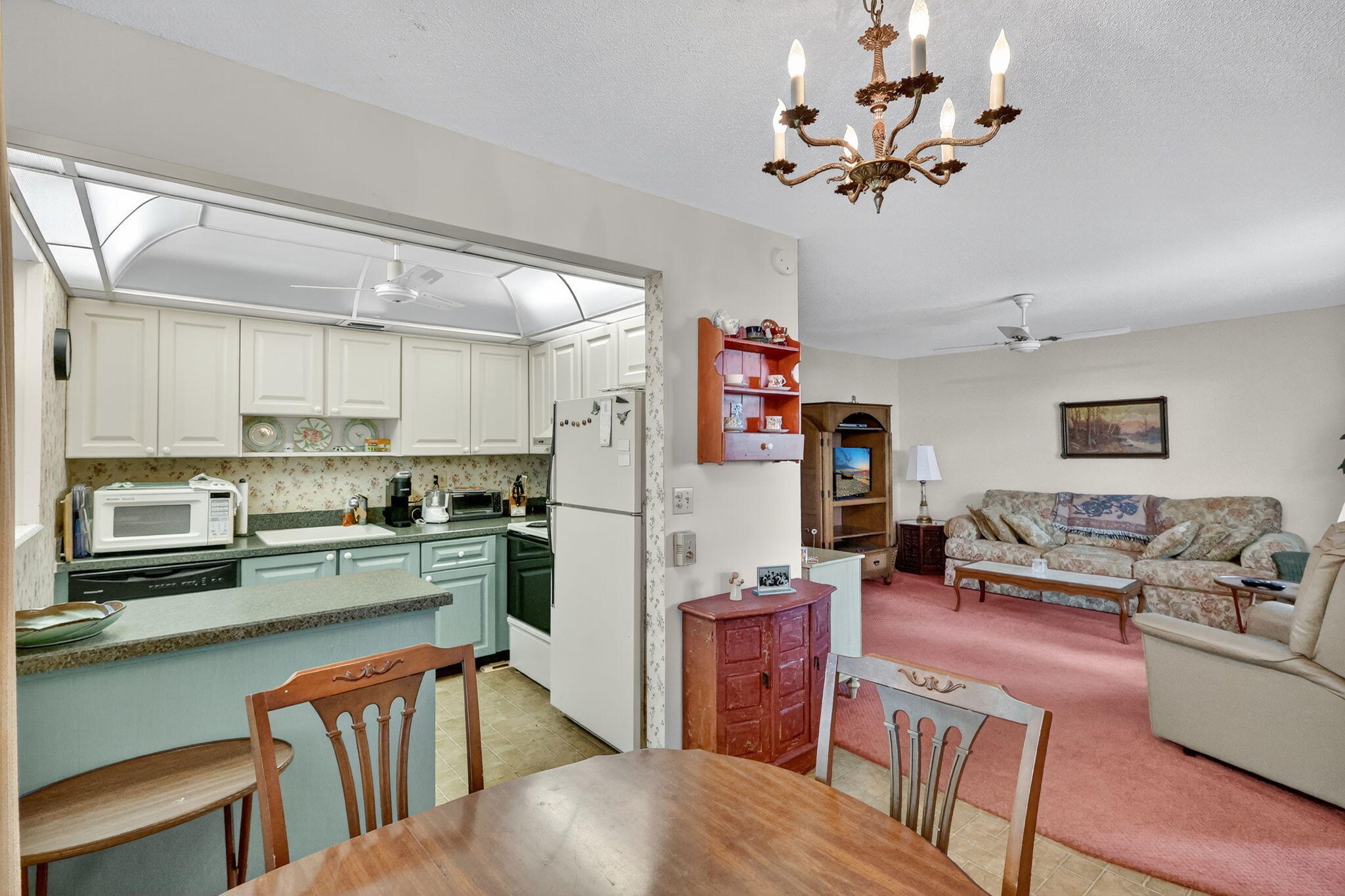 2929 Southeast Ocean Boulevard, Unit J10 Stuart, FL 34996 - Photo 4 of 29 a living room with stainless steel appliances furniture and a kitchen view