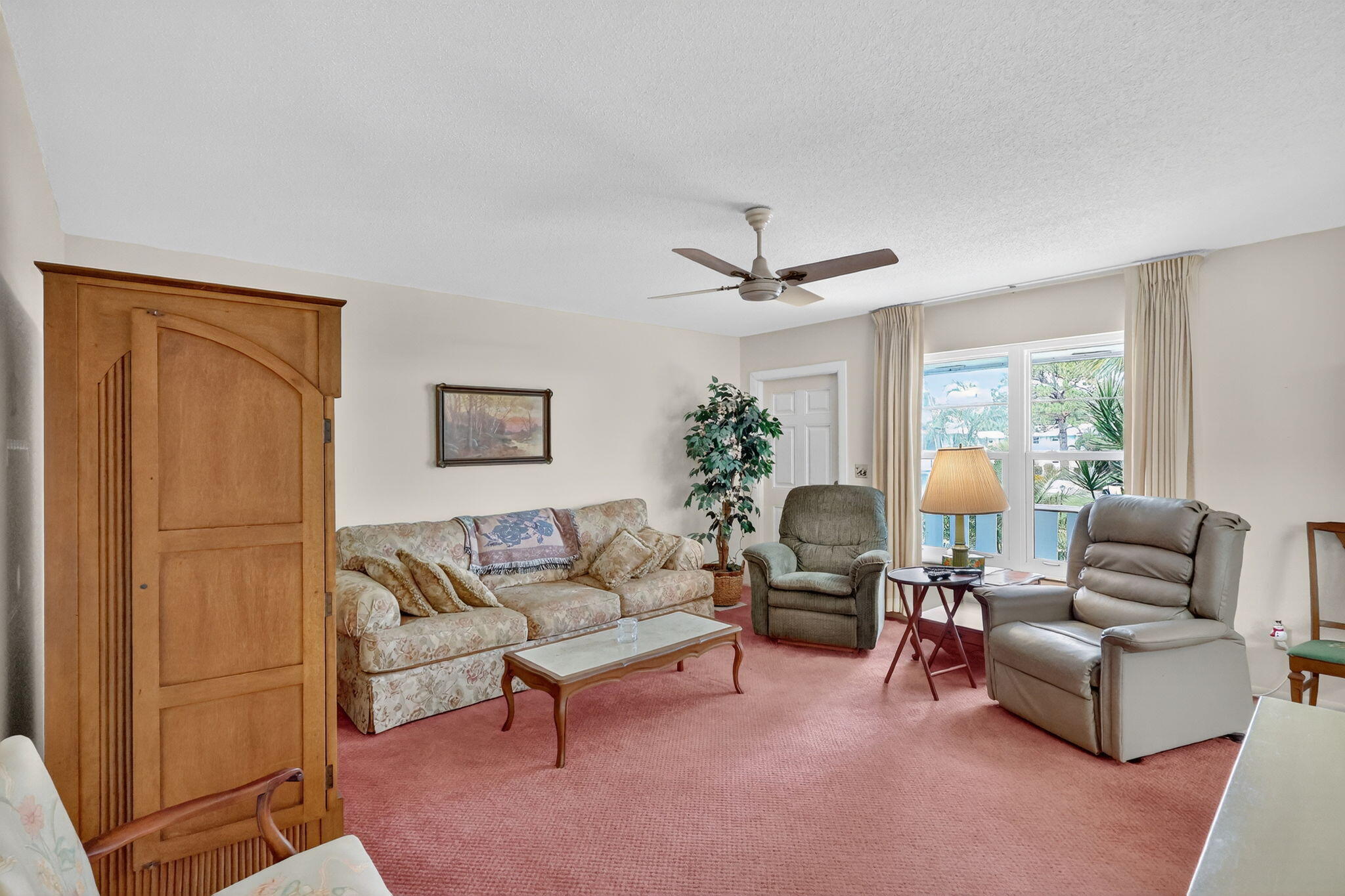 2929 Southeast Ocean Boulevard, Unit J10 Stuart, FL 34996 - Photo 6 of 29 a living room with furniture and a window