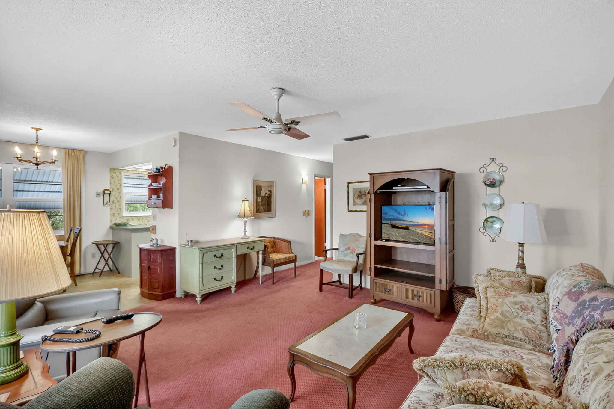 2929 Southeast Ocean Boulevard, Unit J10 Stuart, FL 34996 - Photo 7 of 29 a living room with furniture and a flat screen tv