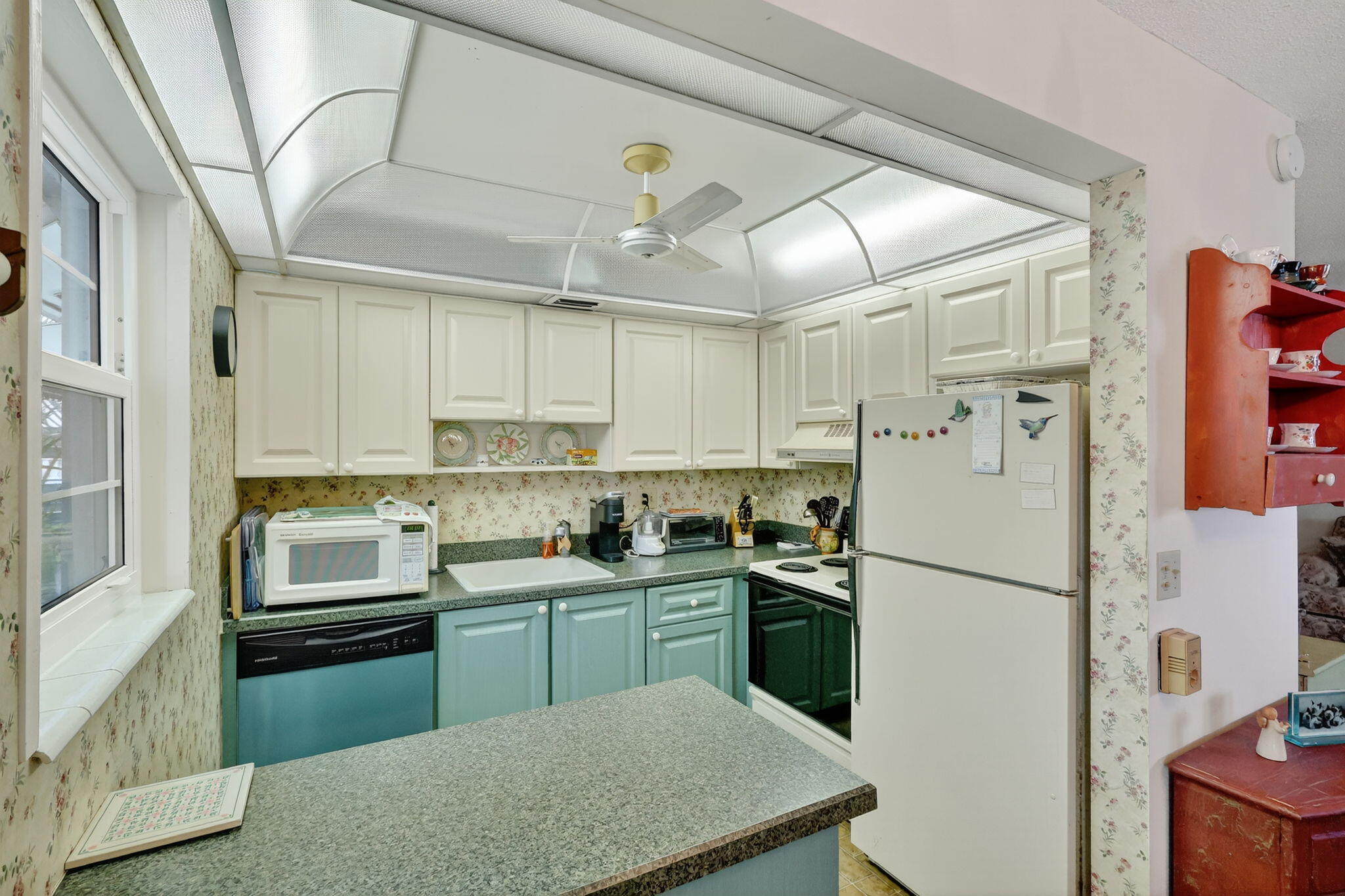 2929 Southeast Ocean Boulevard, Unit J10 Stuart, FL 34996 - Photo 10 of 29 a kitchen with cabinets and stainless steel appliances