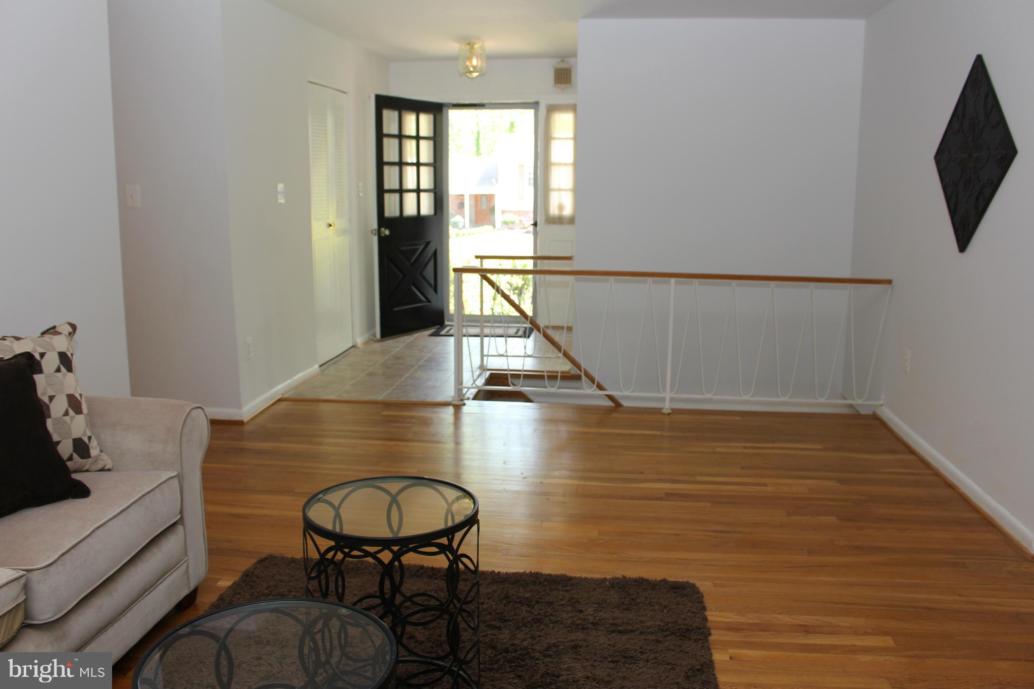 View to foyer and front door from living room