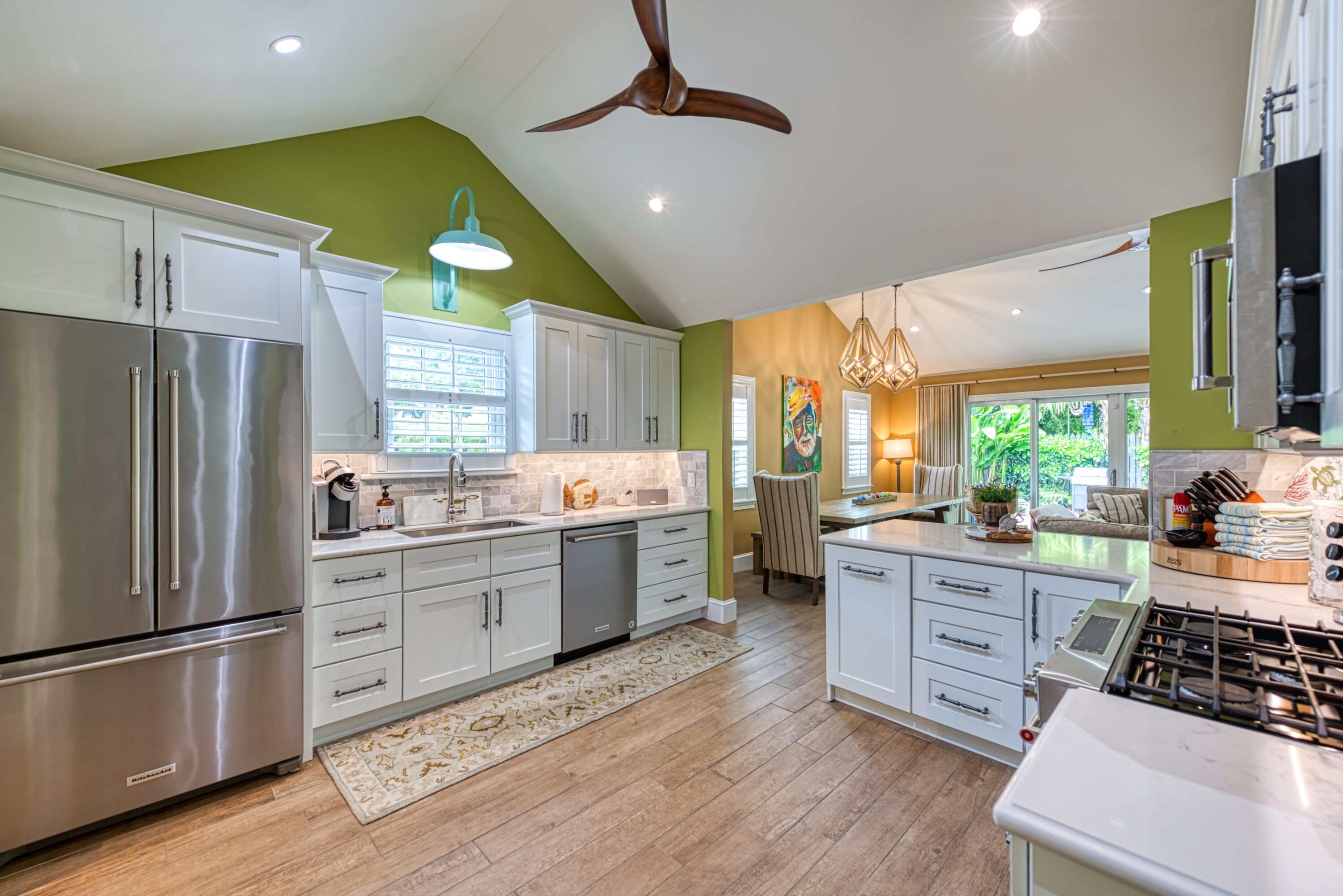 805 Shavers Lane Key West, FL 33040 - Photo 10 of 32 a kitchen with stainless steel appliances a sink a stove a refrigerator cabinets and wooden floor