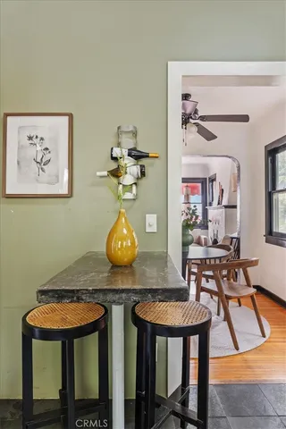 a living room with furniture a window and a flat screen tv