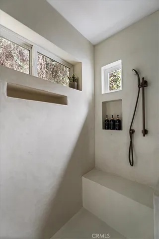 a view of walk in closet with empty racks