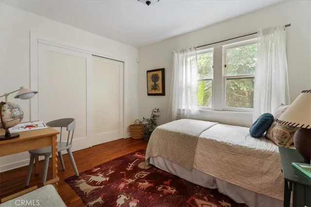 a bedroom with a large bed and a window