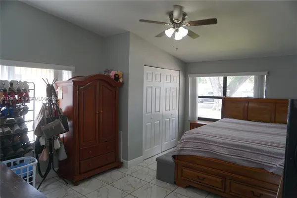 a bedroom with a bed chair and window