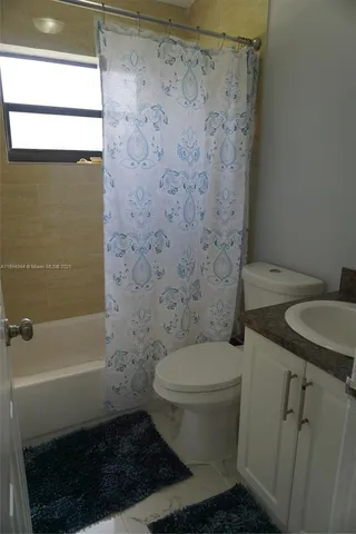 a white toilet sitting next to a bathroom sink