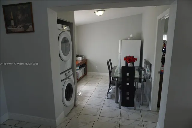 a view of a workspace with furniture and entryway in it