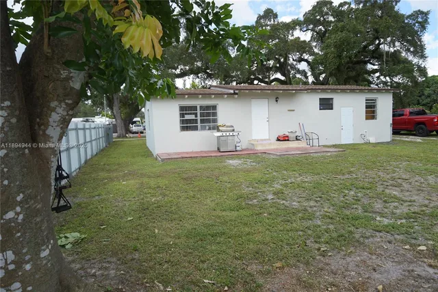 a backyard of a house with table and chairs