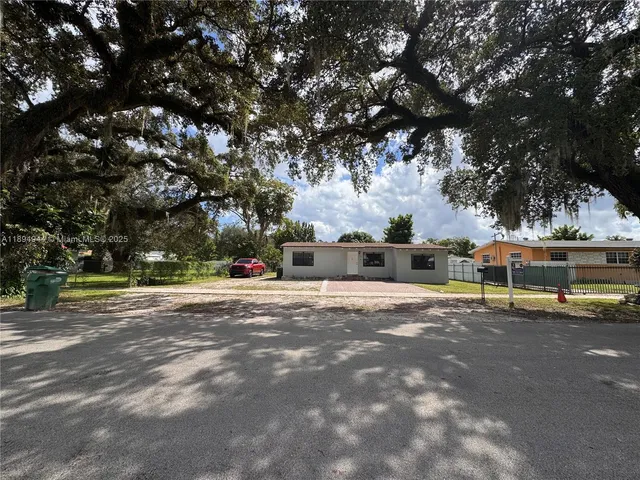 a view of a town with large trees