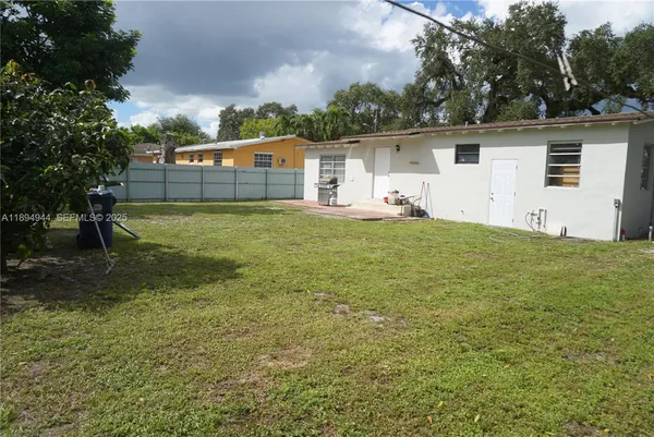 a view of a house with a backyard