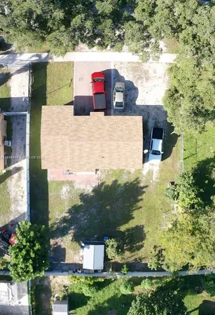 an aerial view of house with yard