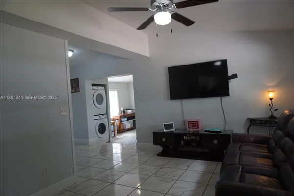 a living room with furniture and a flat screen tv