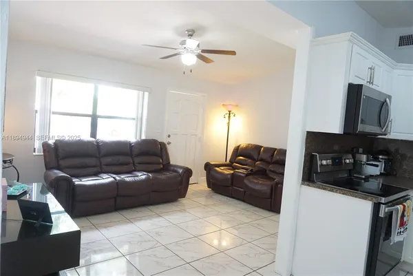 a kitchen with a refrigerator and a stove top oven
