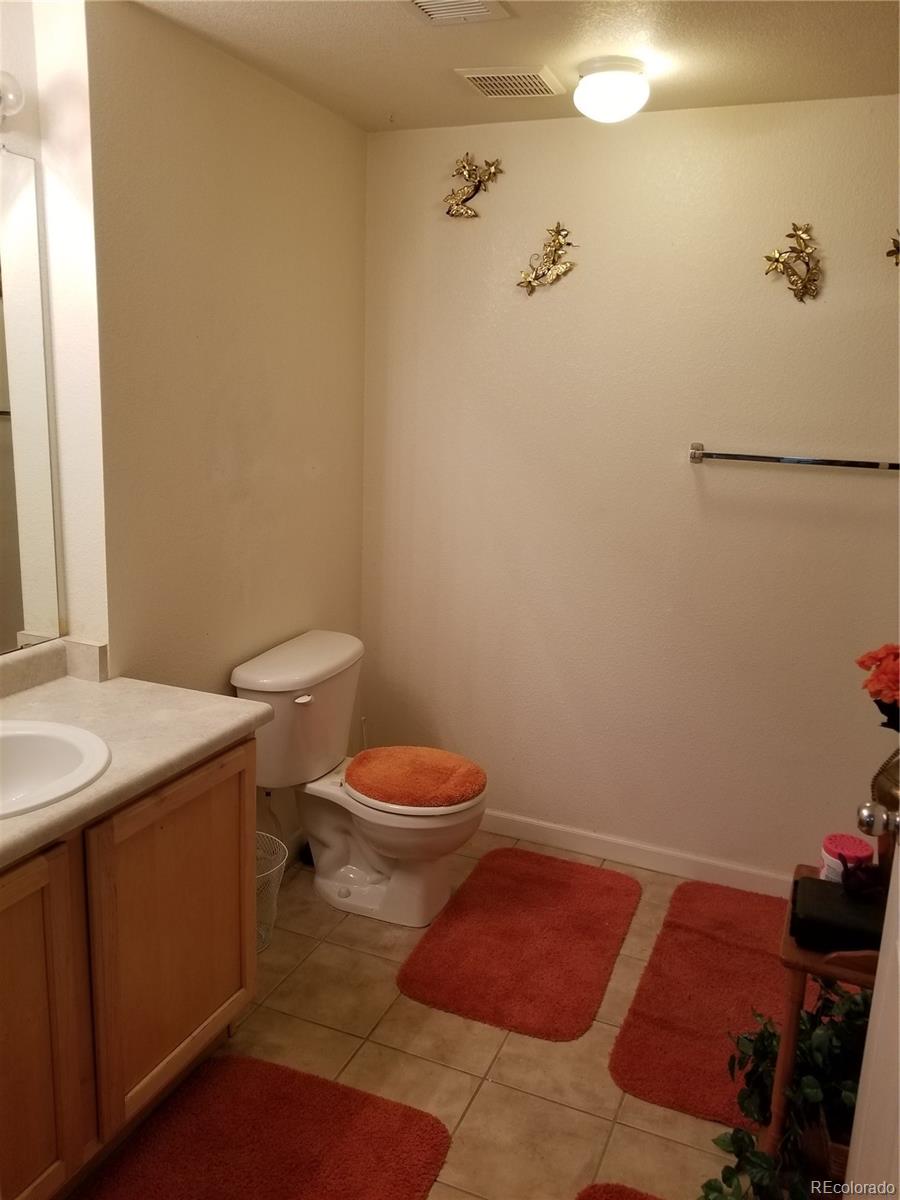 5800 Tower Road, Unit 901 Denver, CO 80249 - Photo 6 of 7 a bathroom with a sink and toilet