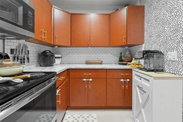 a kitchen with a sink a stove and cabinets