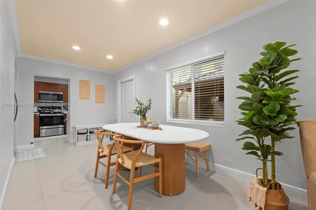 a dining room with furniture and window