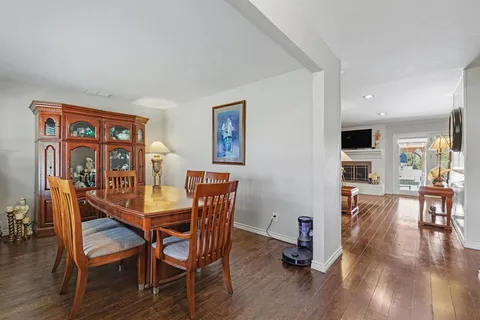 a dining room with furniture and wooden floor
