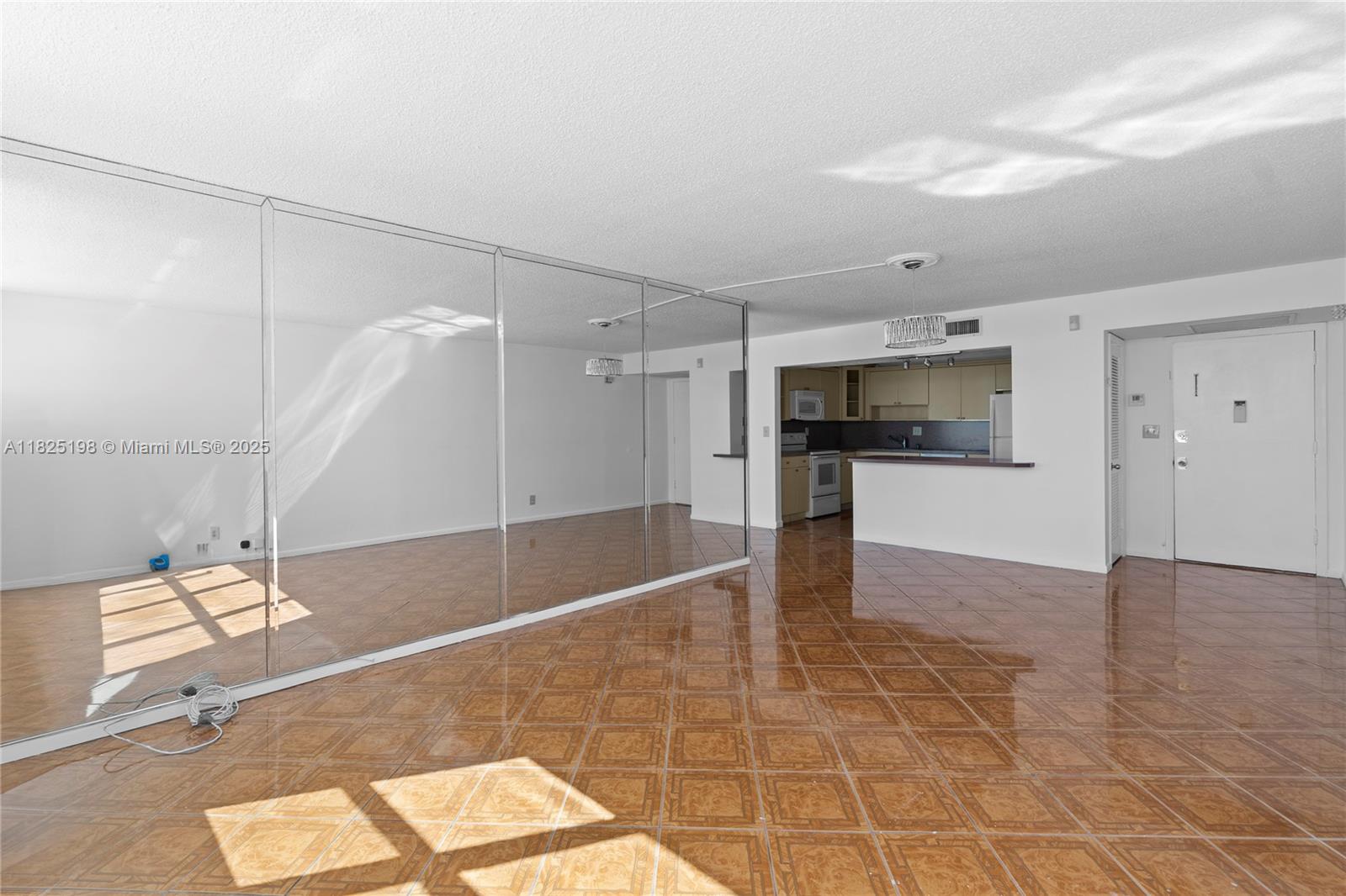 1410 South Ocean Drive, Unit 208 Hollywood, FL 33019 - Photo 27 of 48 a view of a livingroom with wooden floor and a kitchen space