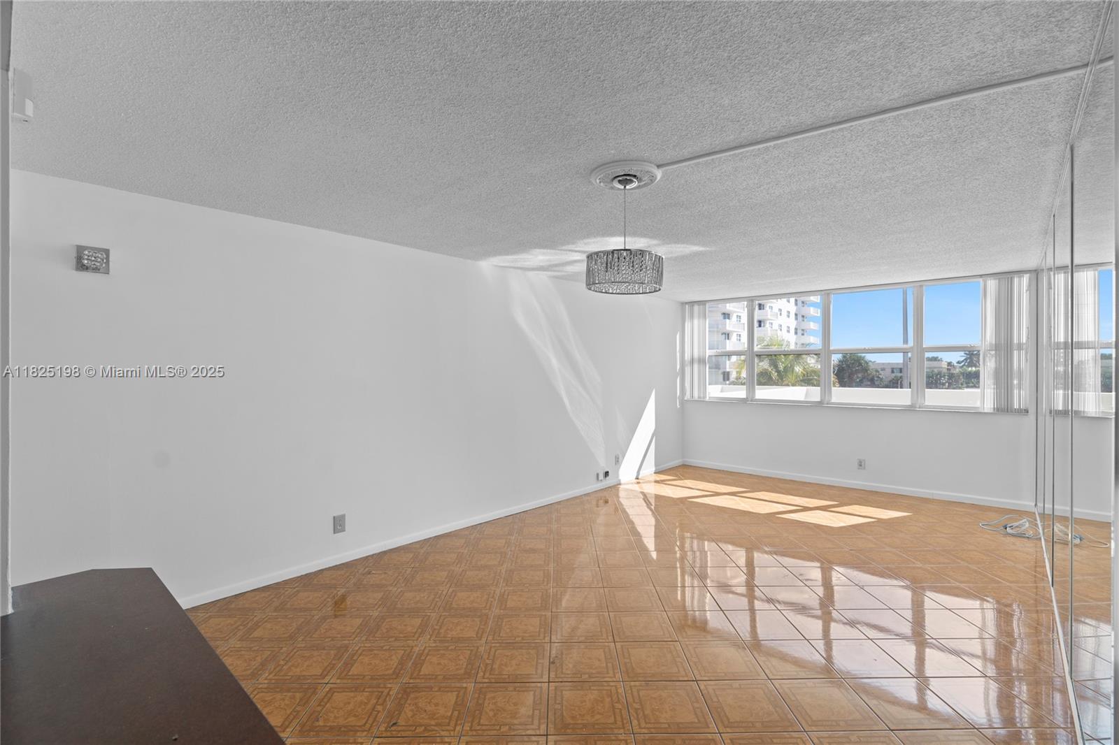 1410 South Ocean Drive, Unit 208 Hollywood, FL 33019 - Photo 28 of 48 a view of kitchen and empty room with wooden floor