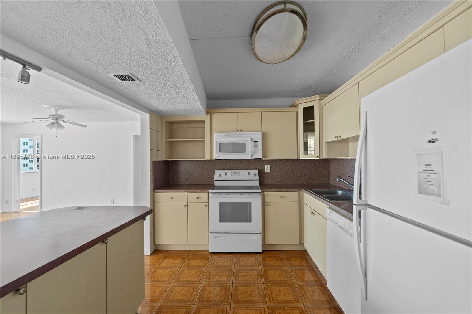 1410 South Ocean Drive, Unit 208 Hollywood, FL 33019 - Photo 32 of 48 a kitchen with a stove cabinets and a refrigerator