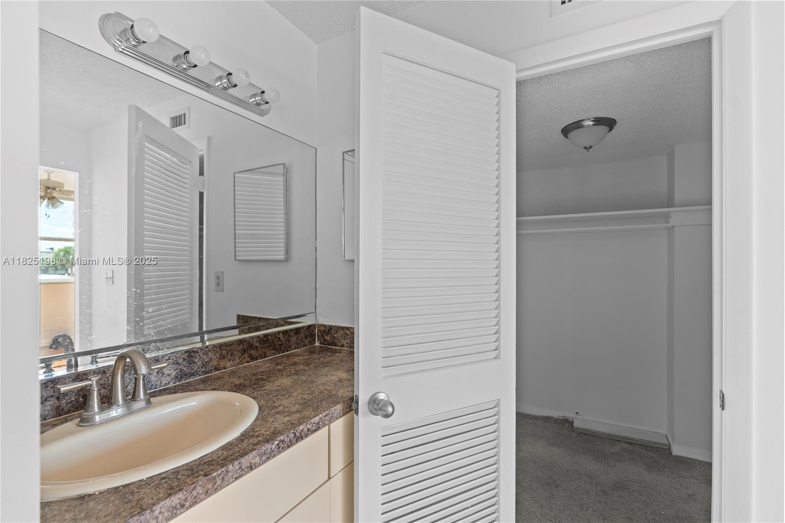 1410 South Ocean Drive, Unit 208 Hollywood, FL 33019 - Photo 41 of 48 a bathroom with a granite countertop sink a mirror and shower