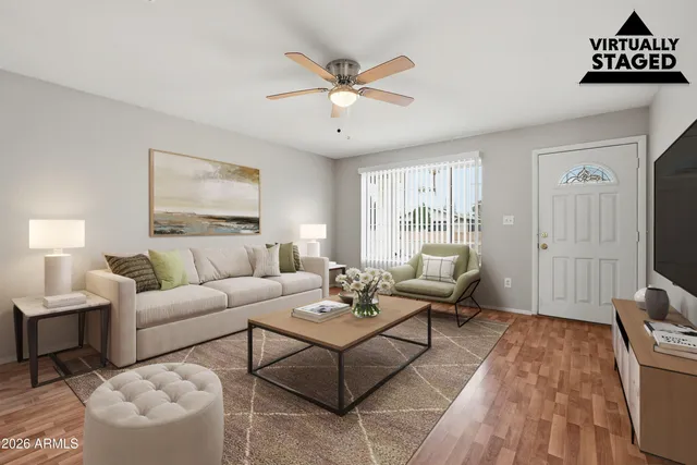 a living room with furniture and wooden floor