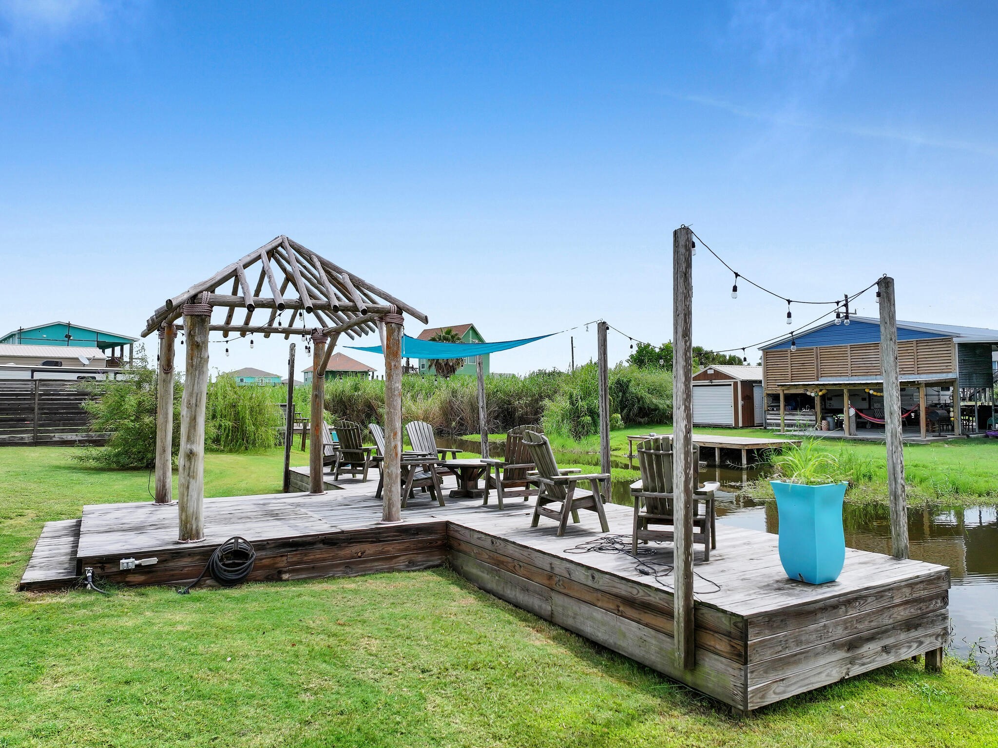 894-896 South Crystal Beach Road Crystal Beach, TX 77650 - Photo 17 of 40 a view of a house with a backyard and patio