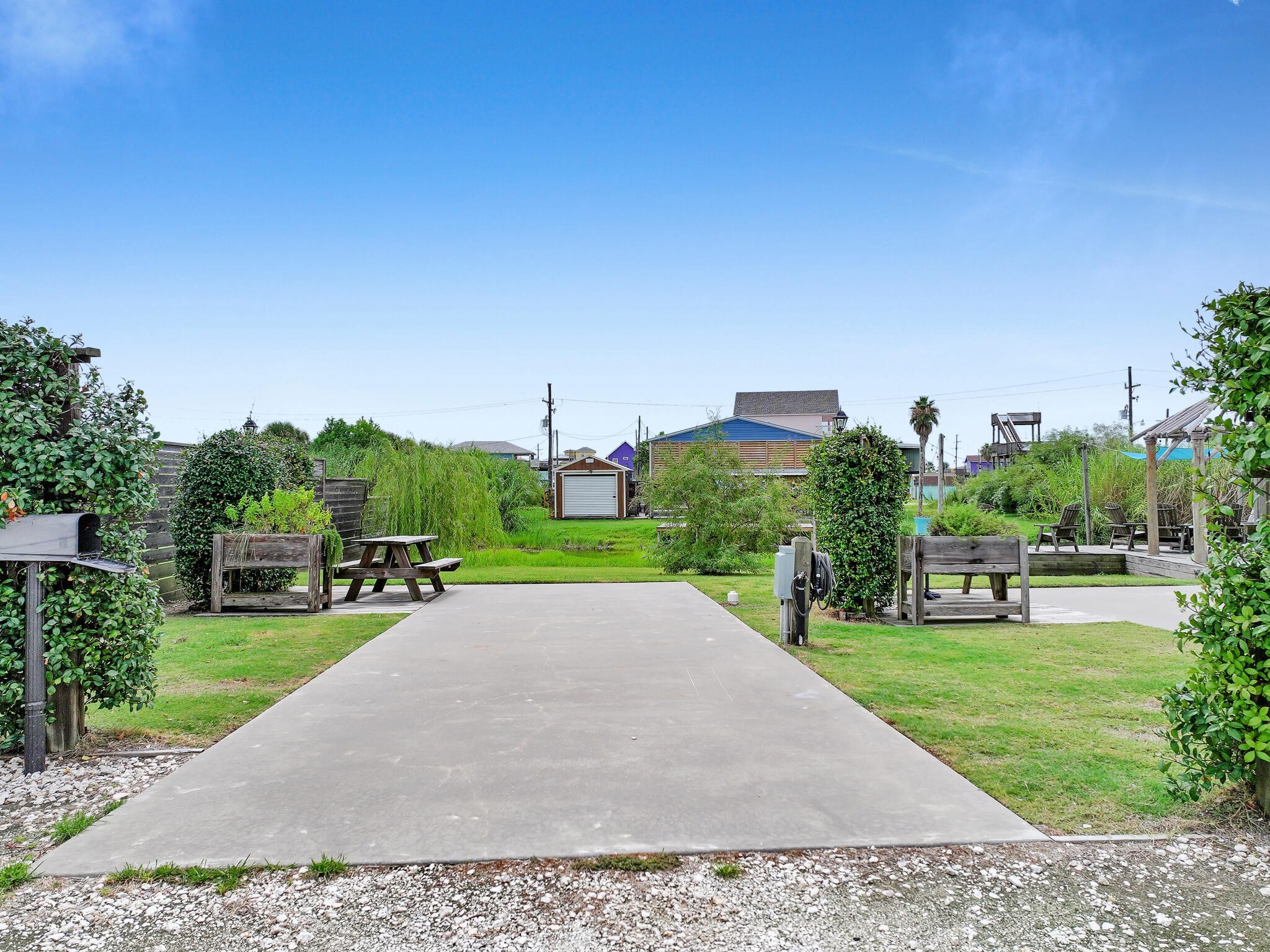 894-896 South Crystal Beach Road Crystal Beach, TX 77650 - Photo 23 of 40 a view of a garden with a building in the background