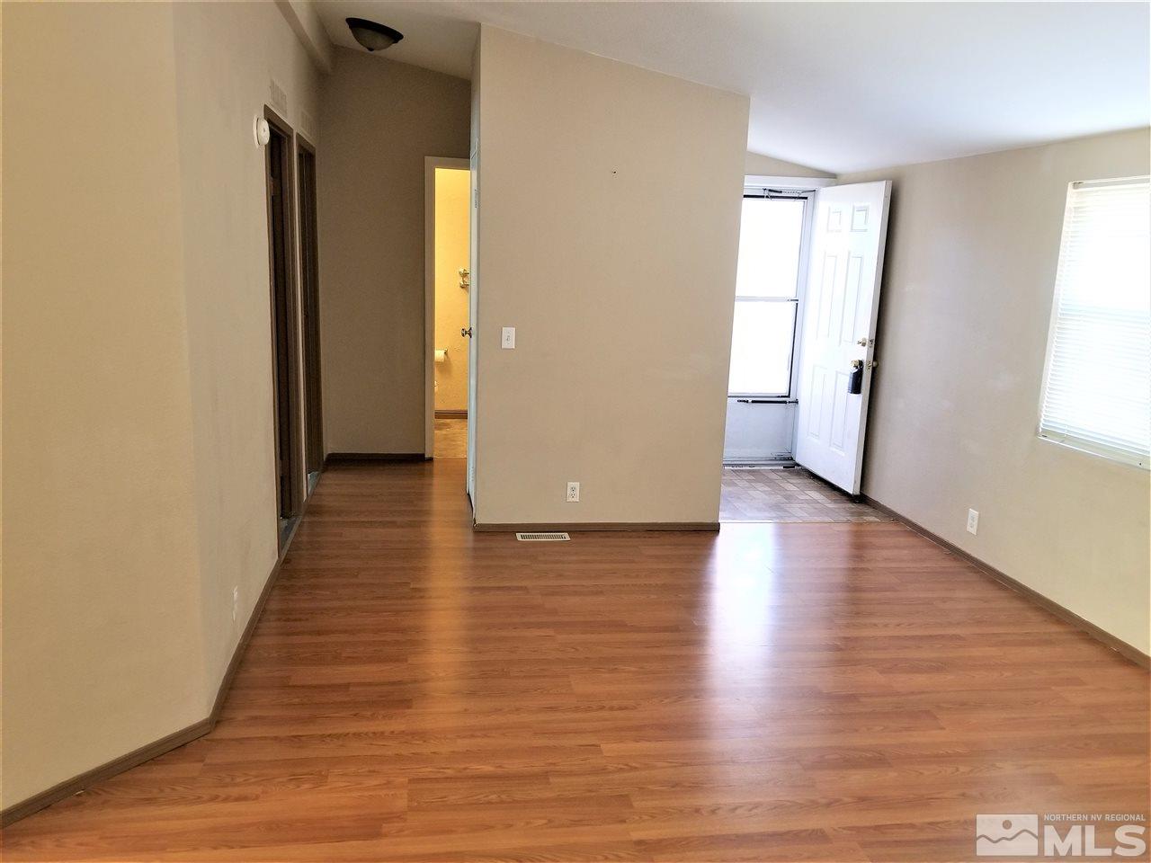 2750 Snapdragon Way Reno, NV 89512 - Photo 4 of 15 an empty room with wooden floor and windows